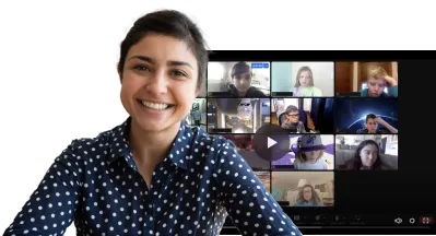 A smiling woman in a polka-dot shirt in front of a virtual classroom with multiple students on a video call.